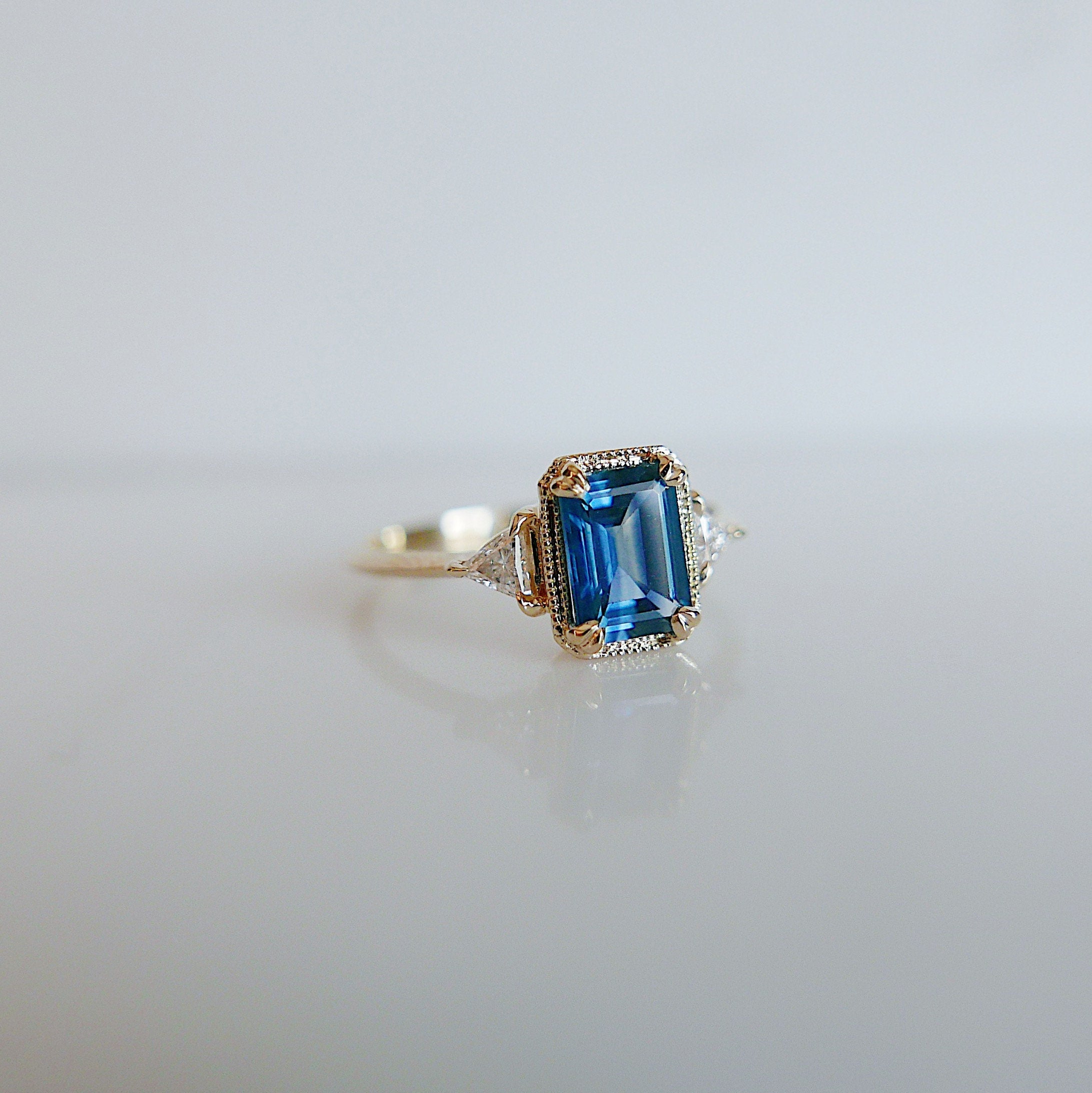 Amelia blue sapphire Ring, 3 stone ring, classic alternative engagement ring, light blue sapphire emerald cut and Diamond trillion ring